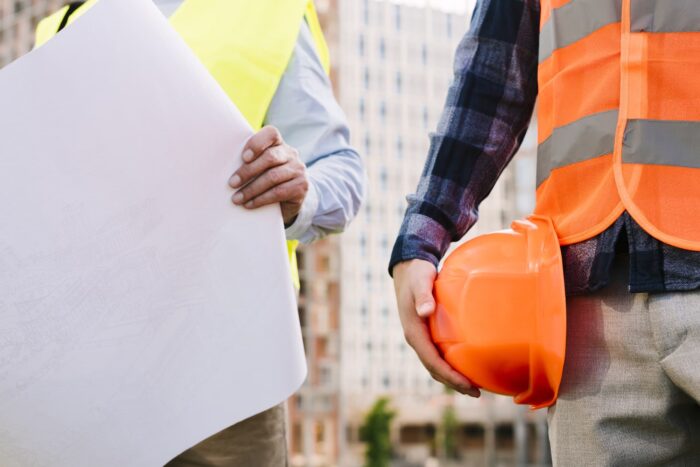 close-up-men-with-safety-vests-helmet